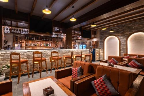 a bar with couches and chairs in a restaurant at Temple Bell Boutique Hotel & Spa in Pokhara