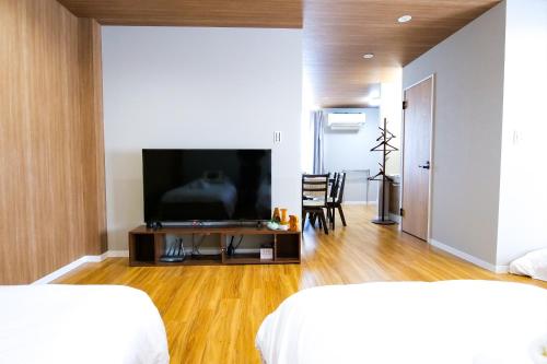 a bedroom with a flat screen tv on a table at Maru 5 Inn in Tokyo