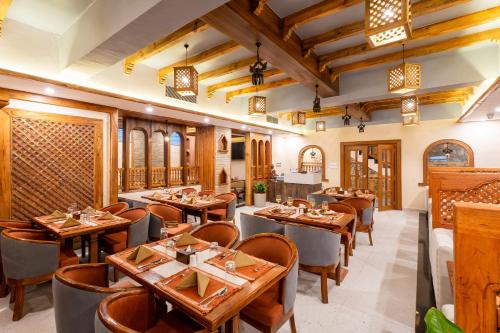 a restaurant with wooden tables and chairs at Temple Bell Boutique Hotel & Spa in Pokhara