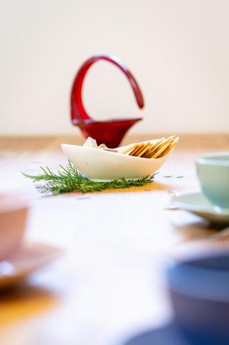 a tea kettle sitting on a table with a plate of food at Apartments and rooms Nataša 2 in Trenta
