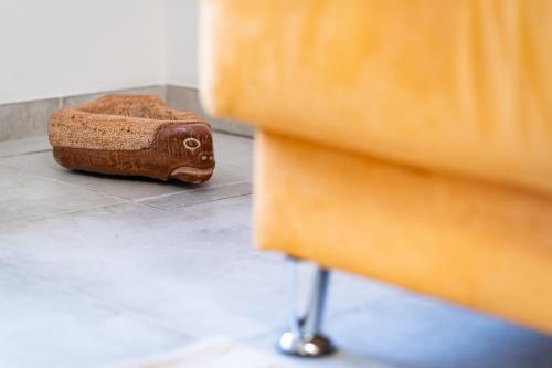 a wooden block sitting on the floor next to a dresser at Apartments and rooms Nataša 2 in Trenta