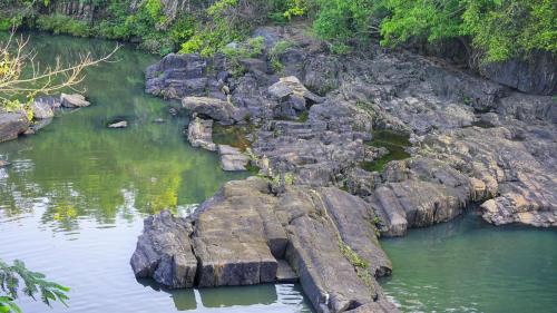 a group of rocks in a body of water at Lake Island Home Stay in Dambulla