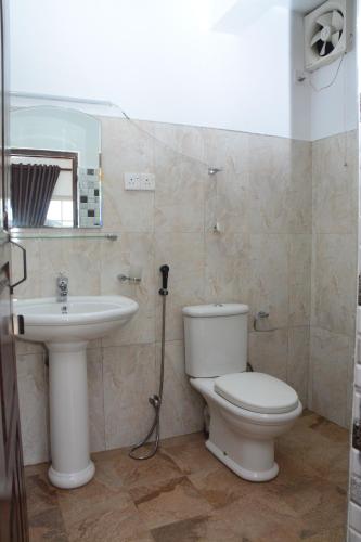 a bathroom with a toilet and a sink at The Fern Inn in Nuwara Eliya