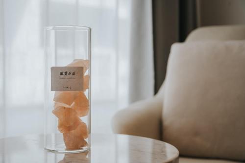 a glass vase filled with brown objects on a table at Guilin Bonjour Boutique Hotel- Free pick up service over 3 nights in Guilin