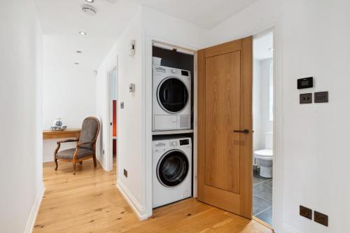 a laundry room with a washer and dryer at Free parking - Villa Apartment - Hosted by StaySejour in Brighton & Hove