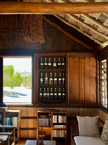 a room with a shelf with bottles of wine at ENTREMER in Belo