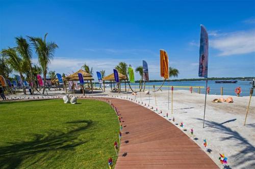 a walkway leading to a beach with umbrellas at Royal Strand Country Garden Danga Bay in Johor Bahru