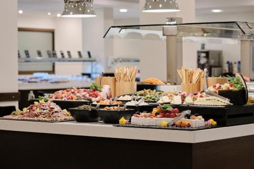 a buffet line with many different types of food at Hotel Helios Costa Tropical in Almuñécar