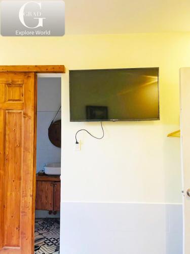 a flat screen tv on the wall of a room at Hoang Yen Villa & Coffee in Da Lat