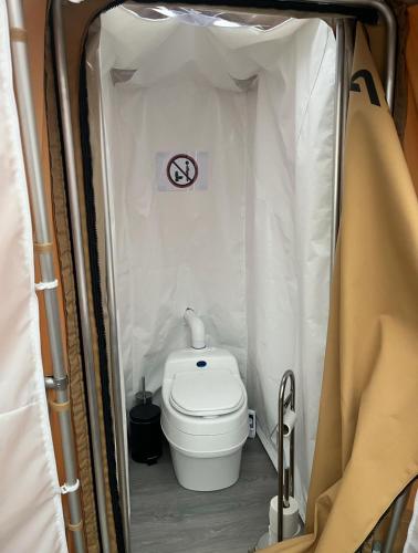 a small bathroom with a toilet in a tent at Arctic Dome Gudbrandsdalen in Sør-Fron