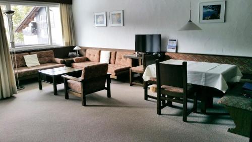 a living room with a couch and a table at Ferienwohnungen Chesa Clois 24 in Lenzerheide