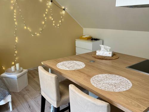 a dining room with a wooden table and chairs at A Studio That Warms the Soul in Tapa