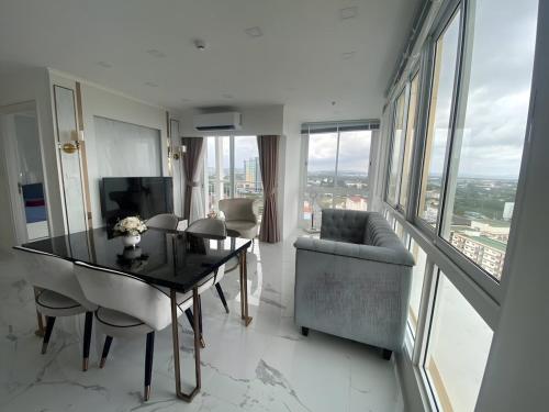 a dining room with a table and a couch at 2 Bed Room Sea View Great Place in Jomtien Beach