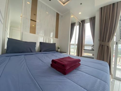 a large bed with a red pillow on top of it at 2 Bed Room Sea View Great Place in Jomtien Beach