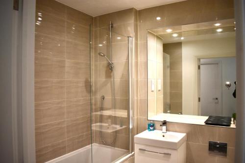 a bathroom with a shower and a toilet and a sink at Breathtaking Camberwell Skyline Views in London