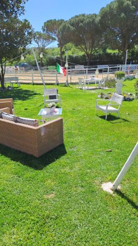 a park with benches and a flag on the grass at Incanto Chic B&B nelle Scuderie in Sacrofano