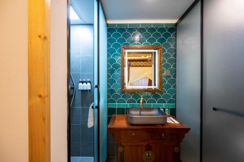 a bathroom with a sink and a mirror at Peking Courtyard Qianmen in Beijing