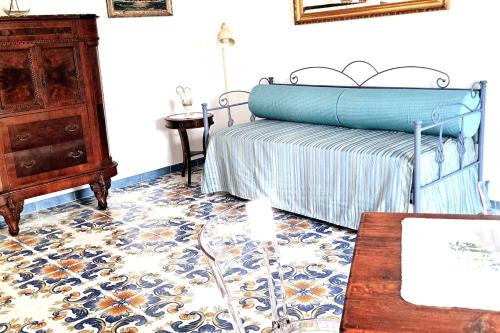 a bedroom with a bed and a dresser and a table at Paomà Sorrento in Agropoli