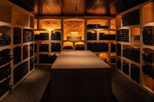 a wine tasting room with a table in the middle at La Chartreuse du Château La Garde in Martillac