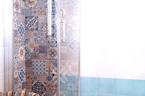 a bathroom with a shower with tiles on the wall at Paomà Sorrento in Agropoli