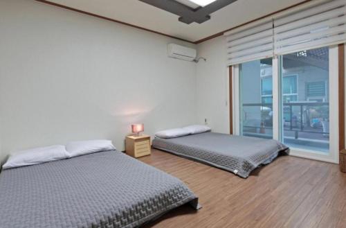 Saturday Pension Gyeongjuにあるベッド