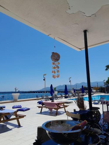 a patio with tables and chairs and a pool at Anemon Kent Ordu Otel in Ordu