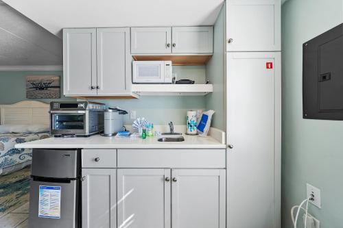 a kitchen with white cabinets and a sink at Beachview 312 in Gulf Shores