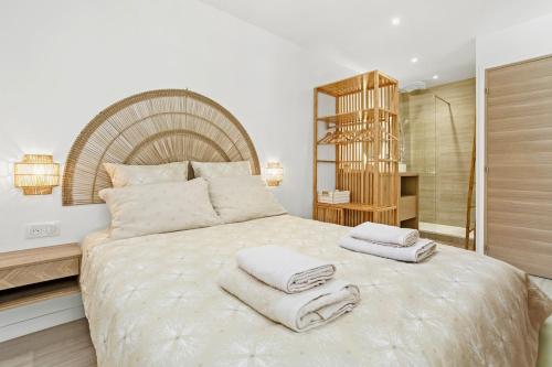 a bedroom with a large bed with towels on it at La Suite Régina - Downtown, terrace, parking in Sainte-Maxime