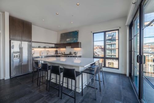 a kitchen with a large white table and chairs at 121 Hotel Floor 3 Buyout by AvantStay Entire Third Floor Buyout of 121 Hotel Sleeps 18 in Nashville