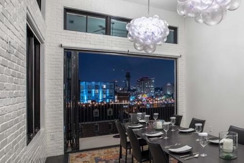 a dining room with a table and a view of the city at 121 Hotel Floor 3 Buyout by AvantStay Entire Third Floor Buyout of 121 Hotel Sleeps 18 in Nashville