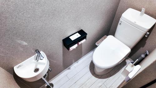 a small bathroom with a toilet and a sink at MSTAY東池袋one in Tokyo