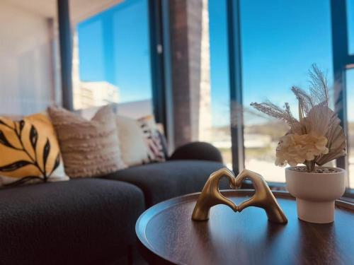 a table with two wooden hearts on it in a living room at Golden Sunset Retreat In Olympic Park in Sydney