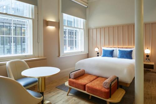a hotel room with a bed and a table and chairs at master Cannon in London