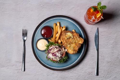 a blue plate of food with french fries and meat at DoubleTree by Hilton Sukhumvit Bangkok in Bangkok