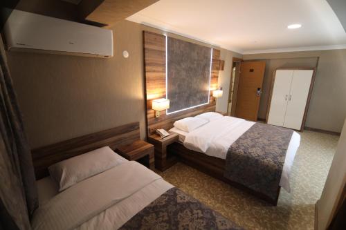 Ένα ή περισσότερα κρεβάτια σε δωμάτιο στο Marbes HOTEL