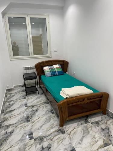 a small bedroom with a bed and a window at Two bedroom luxurious home in Ez Zahra