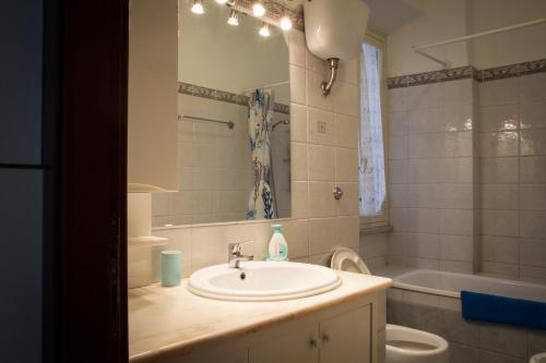 W łazience znajduje się umywalka, toaleta i lustro. w obiekcie Appartamento Residence Sole e Luna w Rzymie