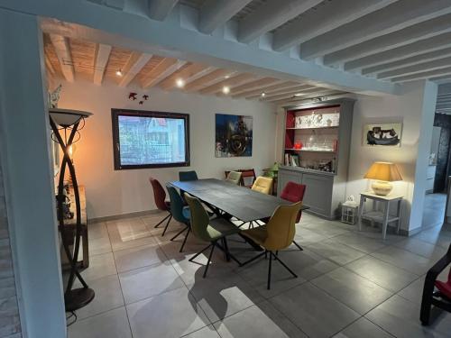 a dining room with a table and chairs at La Fontaine - Détente - Piscine Jacuzzi - 12p in La Chartre-sur-le-Loir
