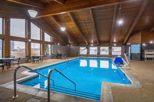 a large swimming pool in a large room with windows at Quality Inn & Suites Harrington - Milford in Harrington