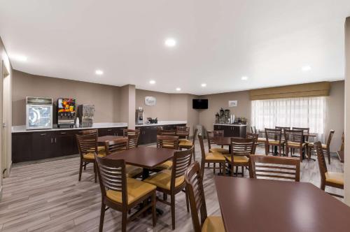 a restaurant with tables and chairs and a bar at Sleep Inn Northlake in Charlotte