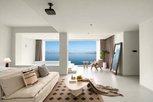 a living room with a couch and a table at Shenzhen GuanHu Secret Wild Reef Seaview Hotel in Shenzhen