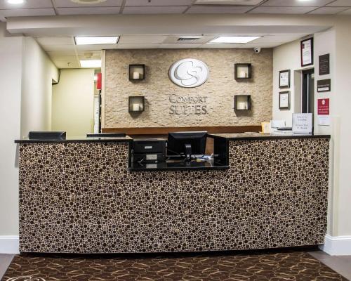 a lobby of a dental office with a reception counter at Comfort Suites University - Research Park in Charlotte