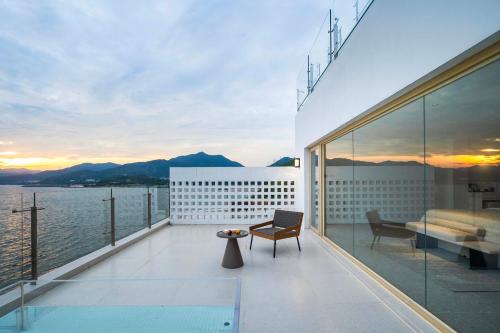 a balcony of a building with a view of the water at Shenzhen GuanHu Secret Wild Reef Seaview Hotel in Shenzhen