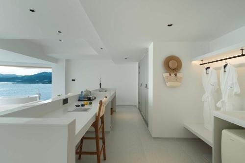 a white kitchen with a counter and two sinks at Shenzhen GuanHu Secret Wild Reef Seaview Hotel in Shenzhen