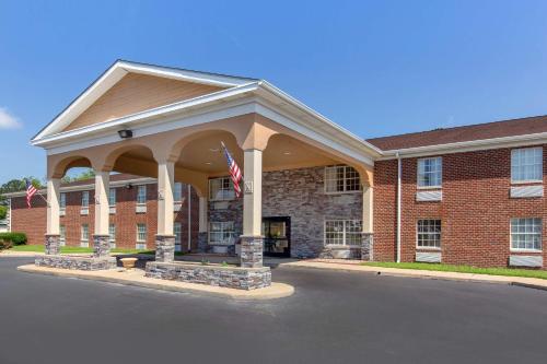 a large brick building with a flag in front of it at Quality Inn Williamston in Williamston
