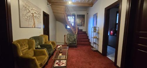 a living room with two chairs and a stairway at Grand Bedir in Istanbul