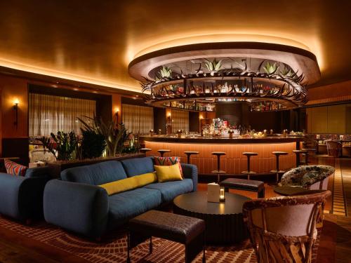 a living room with a couch and a bar at Fairmont Chicago Millennium Park in Chicago