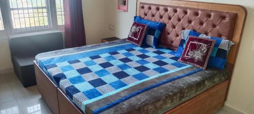 a bed with pillows on top of it at Krishna Hill Stay Near Mall Road in Shimla