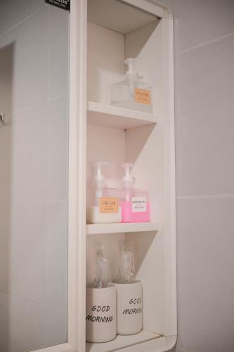 a white cabinet with some items in it at Glory 2 Hue Homestay in Hue