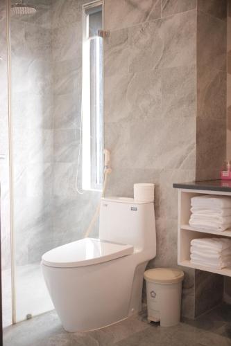 a bathroom with a toilet and a shower at Glory 2 Hue Homestay in Hue